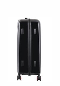 Black hard-shell suitcase with a smooth surface, double zipper, two side handles, and four wheels with red accents at the base.