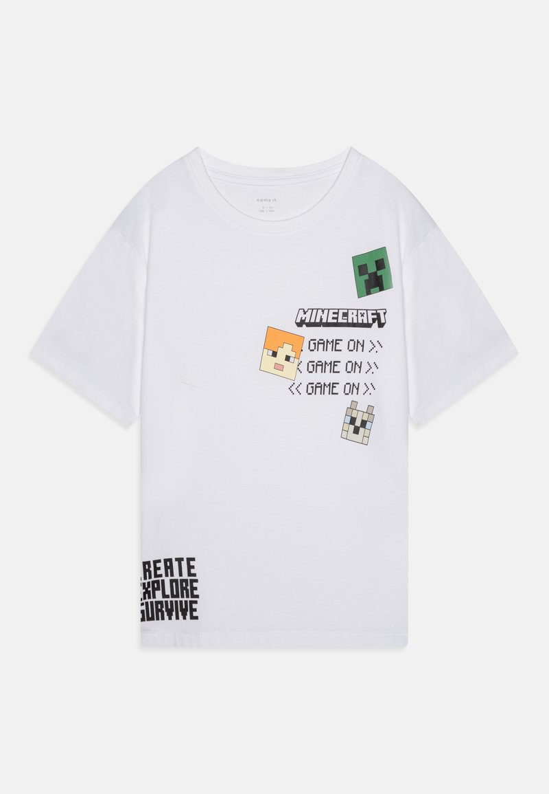 White cotton t-shirt featuring Minecraft graphics: pixelated faces, text "GAME ON," and hashtags "CREATE EXPLORE SURVIVE" in black. Short sleeves.