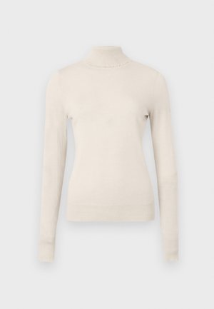 Vaaleanbeige poolopaita, joka on valmistettu pehmeästä neuleesta ja jossa on pitkät hihat sekä herkkä röyhelöyksityiskohta kauluksessa.