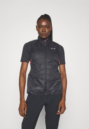 Sort, polstret vest med høj krave, frontlynlås og orange detaljer. Har lynlåsede sidelommer og et slankt, tætsiddende design.
