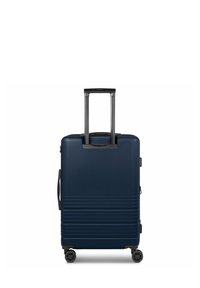 Valise rigide bleu marine avec une surface texturée, poignée noire extensible, prise latérale et quatre roues pour une manœuvrabilité optimale.