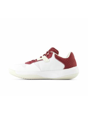 White athletic shoe with red accents, featuring a textured upper and smooth sole. Includes red laces and a secure strap for fit.