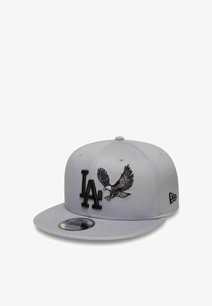 Light gray baseball cap with black LA letters and an embroidered flying eagle on the front, flat brim and adjustable snapback closure.