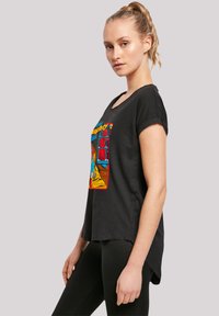 Black cotton t-shirt with a colorful graphic design featuring a character and text. Short sleeves and a relaxed fit with a curved hem.