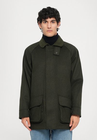 Green wool blend outerwear jacket with a button closure, raglan sleeves, and two front pockets. Textured fabric, collar in matching color.