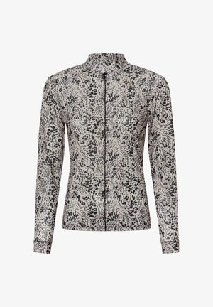 Langärmliges Zip-Up-Oberteil mit hohem Kragen, das ein abstraktes schwarzes und graues Tiermotiv auf leicht beigem Stoff zeigt.