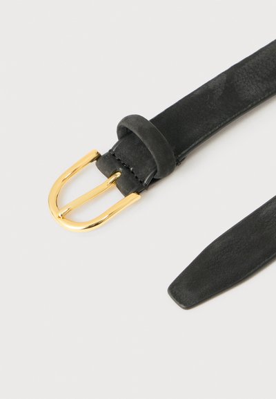 Ceinture en suède noir à texture lisse avec une boucle en métal doré poli sur un fond clair.