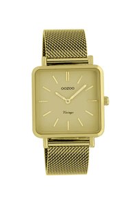 Montre rectangulaire en or avec un bracelet en maille. Le cadran minimaliste présente des index et des aiguilles dorés. Le nom de la marque "OOZOO" est affiché en bas.