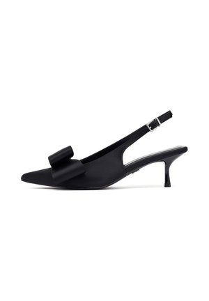 Black slingback pumps with pointed toe, satin finish, featuring a prominent fabric bow on the front and a low, glossy heel.