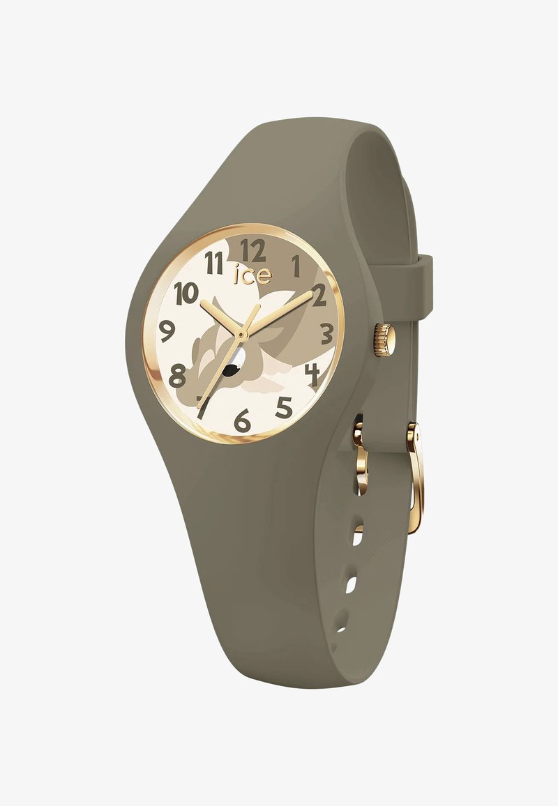 Žalias silikono laikrodis su apvaliu ciferblatu, auksiniais akcentais ir kreminiu ciferblatu, kuriame yra žaisminga gyvūnų iliustracija. Skaičiai yra aiškūs ir ryškūs.