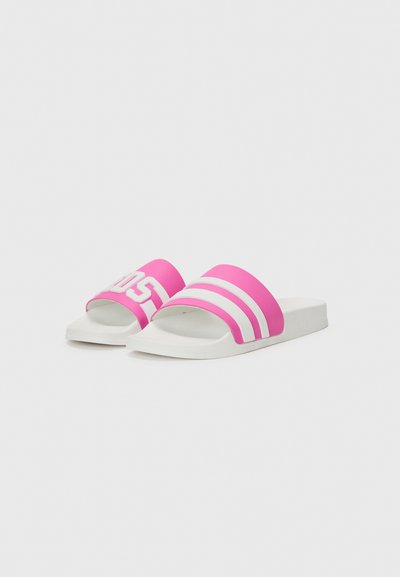 Pink slide sandals with white stripes and branding. Made of rubber, featuring an open-toe design and a flat, cushioned sole.