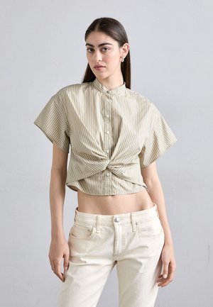 Short-sleeve, cropped shirt in light beige with vertical white stripes, featuring a button-up front and knotted detail at the waist.