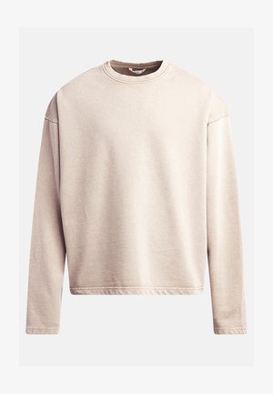 Sweatshirt beige clair avec col rond, manches longues et coupe décontractée. Tissu lisse avec des coutures visibles le long de l'ourlet et des poignets.