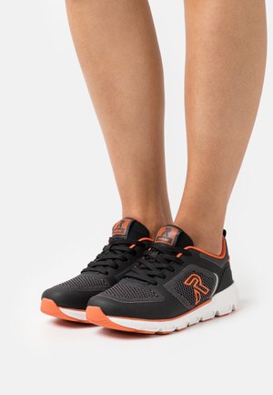 Black athletic shoes with orange accents; mesh upper, rubber sole, and padded collar. Features laces and logo on the side.