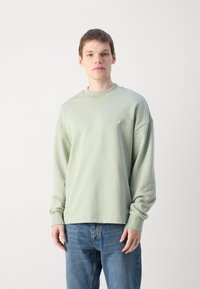 HUGO NINNYO - Felpa - light pastel green