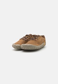 Brown suede shoes with textured grey rubber soles and brown laces. Low-profile design, suitable for casual or outdoor use.