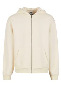 Sweat à capuche crème à fermeture éclair intégrale avec poches kangourou à l'avant, poignets côtelés et capuche, présenté sur un fond blanc.