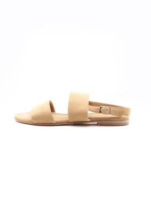 Infradito in suede tan con suola piatta, caratterizzate da due ampie cinghie per il piede e una cinghia regolabile alla caviglia. Design minimalista senza decorazioni.