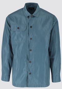 Jasnoniebieska, długorękawowa kurtka wykonana z błyszczącego materiału. Posiada zapięcie na guziki z przodu, jedną kieszeń na piersi oraz czarne napy.