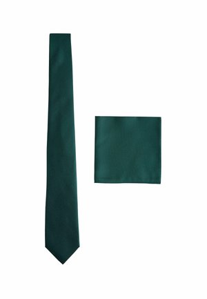 Green patterned tie with a slim shape and a matching pocket square, both featuring a textured fabric in a deep hue.