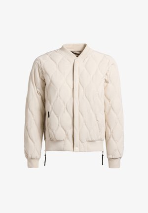 Kreemjas tikandiga bomberjakk laineliste õmblusmustritega, soonikkoes varrukate ja äärega, peidetud ees olevate nööpide ja külgedel asuvate luku detailidega.