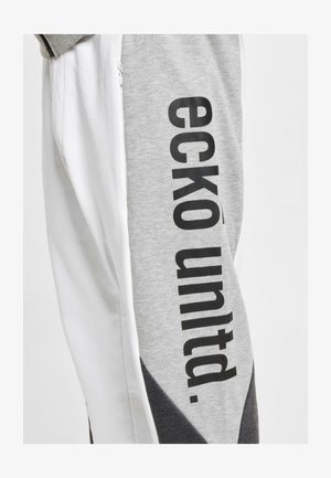 Gray sweatpants with black "eckö unltd." lettering on the side. Features a zip pocket and color-block design with white and dark gray accents.