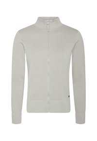 Světle šedá zipová bunda s vysokým límcem, která má herringbone vzor, dlouhé rukávy a žebrované manžety a lem. Minimalistické detaily značky.