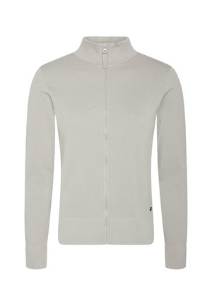 Šviesiai pilkas užtrauktuku užsegamas švarkas su aukštu apykakle, turintis žakardinį tekstūrą, ilgomis rankovėmis ir elastiniais rankogaliais bei apačia. Minimalus logo elementas.