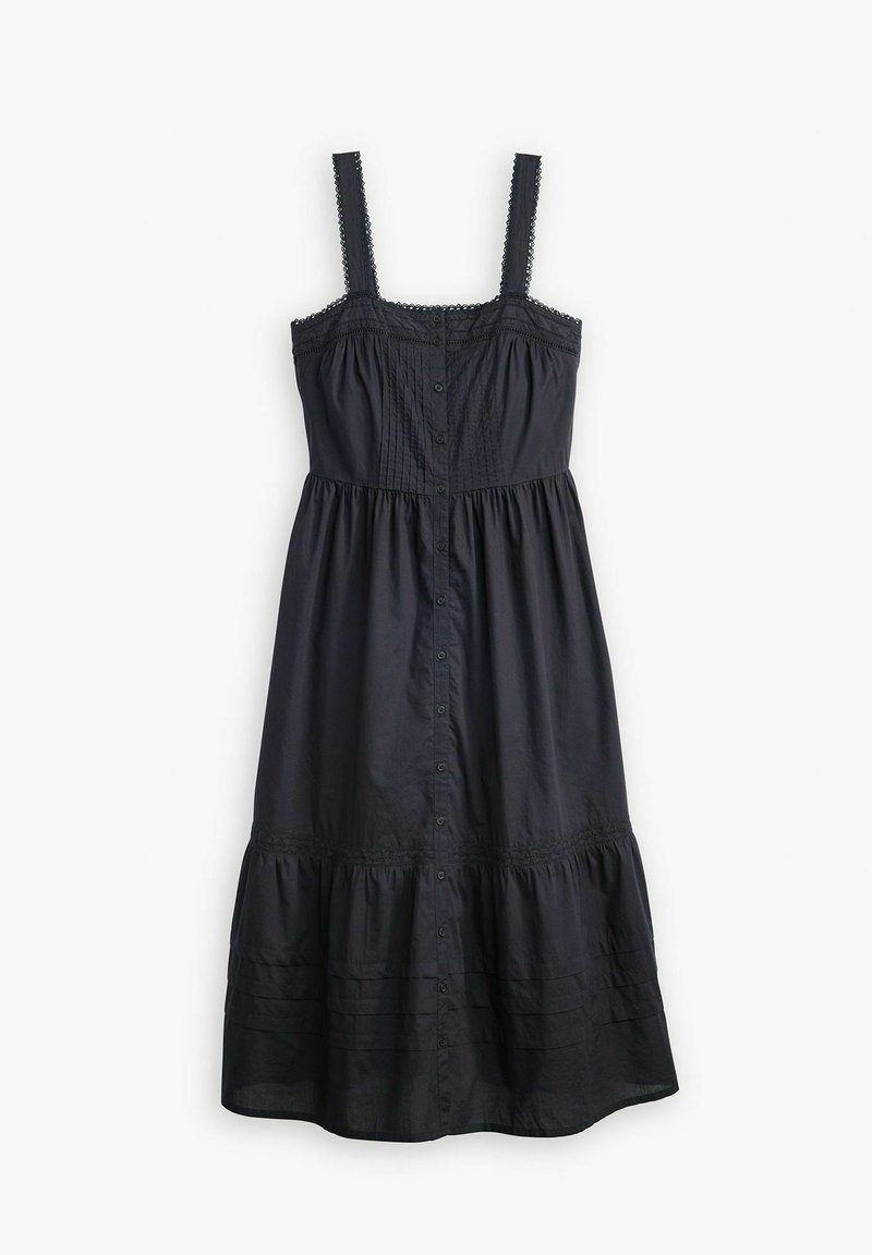 Robe en coton noir avec des bretelles fines, fermeture boutonnée sur le devant, corsage texturé avec des plissés, et une jupe à volants avec des accents en dentelle à la taille.