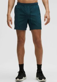 Zöldeskék fürdőnadrág rugalmas derékkal és zsinórral, elülső zsebekkel és sima, könnyű szövettextúrával.