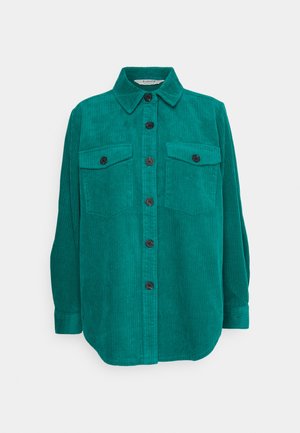 Teal corduroy shirt with a collared neck, front button closure, and two chest pockets featuring black buttons. Fitted long sleeves with cuffs.