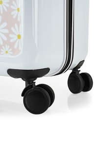 Maleta rígida de color blanco con un patrón floral en rosa, con ruedas y cremallera negras, superficie lisa con acabado brillante.