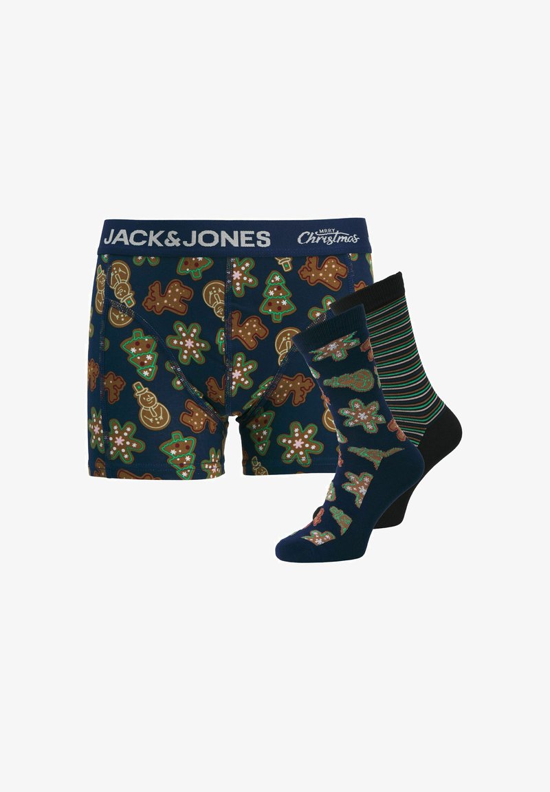 Boxers bleu marine avec des motifs de pain d'épice et d'arbre de Noël, associés à une chaussette rayée et une chaussette assortie au design des boxers.