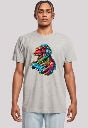 Gray t-shirt featuring a colorful graphic of a dinosaur wearing headphones and holding a video game controller. Short sleeves, casual fit.