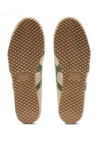 Green and cream sneakers with a textured rubber sole, featuring a diamond pattern and embossed logo on the sole, designed with lateral stripes.