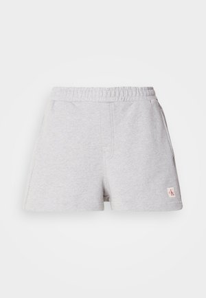 Pelēki kokvilnas šorti ar elastīgu jostu, sānu kabatām un mazu logotipa uzšuvi uz apakšmalas. Mīksta tekstūra, brīvs griezums, ikdienišķs dizains.