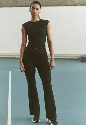 Next, ULTIMATE COMFORT CROSS FRONT HIGH WAIST SPORTS LEGGINGS - Leggings - Hosen - black