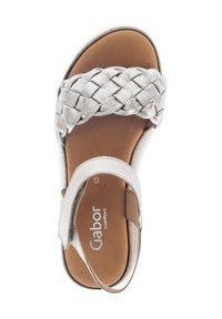Braided silver leather sandal with a brown insole, adjustable strap, flat sole, and brand logo on the footbed, top view.