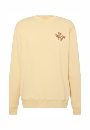 Felpa gialla con collo rotondo, polsini e fondo a costine. Presenta la scritta "Do Nothing Club" stampata in marrone sul lato sinistro del petto. Materiale morbido in misto cotone.