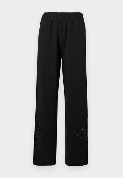 Schwarze weit geschnittene Hosen aus weichem Stoff, mit einem elastischen Bund und einem dekorativen Nieten-Design am Saum.