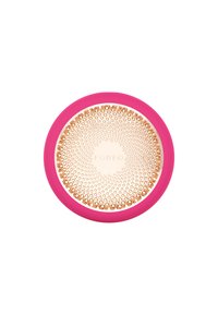 Pink silicone handheld device with a textured gold circular surface, featuring small holes and the word "FOREO" in the center.