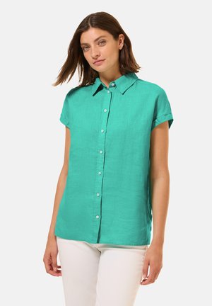 Een kortärmelige, geknoopte blouse met kraag in helder turquoise stof, met een ontspannen pasvorm en een gladde textuur.