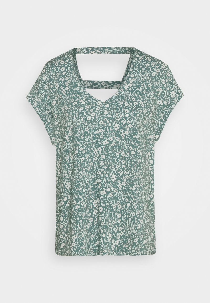 Grønn kortermet bluse med hvit blomsterprint og firkantet utskjæring ved nakken bak.