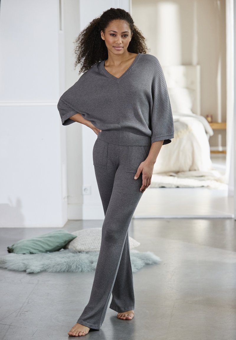 Grijze gebreide lounge set met een losse V-hals top en flare broeken met een getextureerd ribbelontwerp en voorzakken.