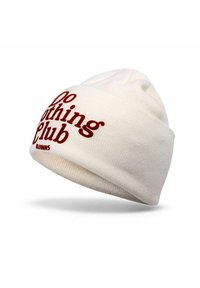 Cremfarbener Strickbeanie mit umgeschlagenem Rand. Enthält roten Text mit der Aufschrift "Do Nothing Club" und "DJ INNS." Weicher Stoff und eng anliegendes Design.