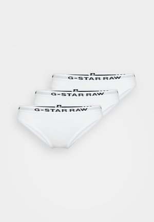 Witte katoenen bralette met dunne banden en een V-hals, gecombineerd met bijpassende witte slipjes met een zwarte logo tailleband. Gladde textuur.