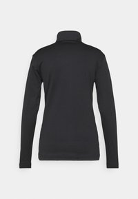 Chemise noire à manches longues et col roulé vue de dos, silhouette ajustée, sur un fond neutre.