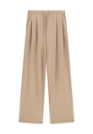 Beige Hosen mit weitem Bein, Kordelzug an der Taille, Seitentaschen, plissiertem Vorderteil und dezentem Guess-Logo auf der rechten Seite.