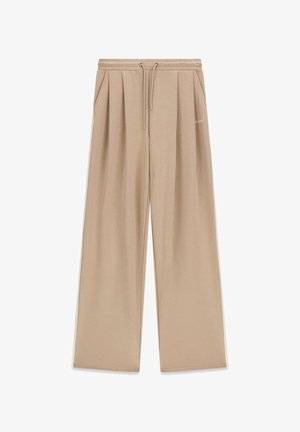 Beige Hosen mit weitem Bein, Kordelzug an der Taille, Seitentaschen, plissiertem Vorderteil und dezentem Guess-Logo auf der rechten Seite.