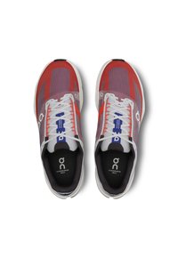 Red and white athletic shoes with a mesh upper, featuring a textured design and contrasting blue accents. Laces and padded insoles included.